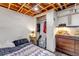 Cozy basement bedroom with exposed wood ceiling, painted walls, closet, and carpeted floors at 2700 W 91St Ave, Denver, CO 80260