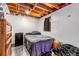 Cozy basement bedroom with exposed wooden ceiling, painted walls, and carpeted floors at 2700 W 91St Ave, Denver, CO 80260