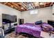 Cozy basement bedroom with exposed ceiling, painted walls, and bed with purple covers at 2700 W 91St Ave, Denver, CO 80260