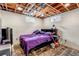 Cozy basement bedroom with exposed wood ceiling, painted walls, and carpeted floors at 2700 W 91St Ave, Denver, CO 80260