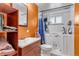 Cozy bathroom featuring a jacuzzi tub and sink, complemented by bright orange walls at 2700 W 91St Ave, Denver, CO 80260