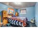 Bright bedroom filled with Denver Bronco's memorabilia, featuring a cozy bed and cheerful decor at 2700 W 91St Ave, Denver, CO 80260