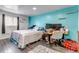 Bright bedroom with wood look floors, a large bed, and a work from home space at 2700 W 91St Ave, Denver, CO 80260