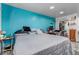 Bright, minimalist bedroom with sleek wood floors, a comfortable bed, and a calming blue accent wall at 2700 W 91St Ave, Denver, CO 80260