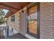 Charming front entrance with decorative screen door and brick accents, adding a touch of elegance at 2700 W 91St Ave, Denver, CO 80260