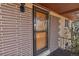 Close up of screen door with brick accents, complemented by unique details, adding character at 2700 W 91St Ave, Denver, CO 80260