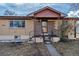 Close up of the front porch with brick columns and walkway leading to a screen door entry at 2700 W 91St Ave, Denver, CO 80260