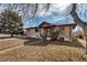 Tan brick home with a mature trees and a front yard, offering classic curb appeal at 2700 W 91St Ave, Denver, CO 80260
