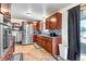Spacious kitchen with stainless steel appliances, tile backsplash, and ample counter space at 2700 W 91St Ave, Denver, CO 80260