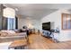 Relaxing living room featuring hardwood floors, a comfortable couch and an entertainment center at 2700 W 91St Ave, Denver, CO 80260