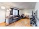 Comfortable living room with a modern sofa, hardwood floors, and natural light from the window at 2700 W 91St Ave, Denver, CO 80260