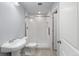 Clean basement bathroom with a tiled shower and white fixtures at 1018 Mcmurdo Cir, Castle Rock, CO 80108