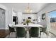 Open concept dining area with a large table and green chairs next to the kitchen at 1018 Mcmurdo Cir, Castle Rock, CO 80108