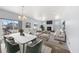 Open concept dining area with a large table, green chairs, and access to a deck at 1018 Mcmurdo Cir, Castle Rock, CO 80108