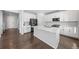 Modern kitchen with white cabinets, stainless steel appliances and a large island at 1018 Mcmurdo Cir, Castle Rock, CO 80108