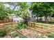 Backyard with a garden area, lush greenery, and a two-story home creates a serene outdoor retreat at 915 Mercury Cir, Littleton, CO 80124