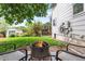 Relaxing backyard with a fire pit, green grass, shed, and a charming outdoor space perfect for gatherings at 915 Mercury Cir, Littleton, CO 80124