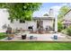 Enjoy this inviting backyard patio with a dining set, grill, and beautifully landscaped surroundings, perfect for outdoor entertaining at 915 Mercury Cir, Littleton, CO 80124
