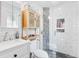 Modern bathroom with glass enclosed shower, storage and sleek fixtures at 915 Mercury Cir, Littleton, CO 80124