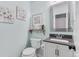 Charming powder bathroom with stylish vanity, mirror and decorative accents at 915 Mercury Cir, Littleton, CO 80124