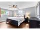 Comfortable bedroom with a ceiling fan, hardwood floors, and lots of natural light at 915 Mercury Cir, Littleton, CO 80124
