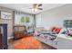 Bright bedroom with a ceiling fan, window, and whimsical decor, creating a cozy and inviting atmosphere at 915 Mercury Cir, Littleton, CO 80124