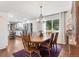 Charming dining room with hardwood floors, a wooden table, and ample natural light and modern chandelier at 915 Mercury Cir, Littleton, CO 80124