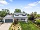 Charming two-story home with a well-manicured lawn, solar panels, and a two-car garage at 915 Mercury Cir, Littleton, CO 80124