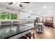 Kitchen features black countertops, stainless appliances, and an island prep station at 915 Mercury Cir, Littleton, CO 80124