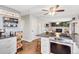 Kitchen features modern appliances, an island prep station and views to the living space at 915 Mercury Cir, Littleton, CO 80124