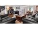 Spacious living room with hardwood floors and an open layout to the kitchen and dining area at 915 Mercury Cir, Littleton, CO 80124