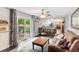 Open concept living room features access to an outdoor patio and views of the kitchen at 915 Mercury Cir, Littleton, CO 80124