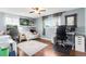 Stylish living room with hardwood floors, a ceiling fan, and a comfortable workspace at 915 Mercury Cir, Littleton, CO 80124