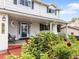 Inviting porch with seating area, potted plants, and charming details on a well-maintained home exterior at 915 Mercury Cir, Littleton, CO 80124