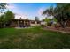 Lush backyard with a fire pit, inviting patio, and a well-maintained lawn at 2840 S Yates St, Denver, CO 80236