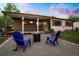 Inviting backyard with a covered patio and fire pit, perfect for outdoor entertaining at 2840 S Yates St, Denver, CO 80236