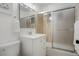 Clean bathroom with a modern vanity, a glass-enclosed shower, and sleek fixtures at 2840 S Yates St, Denver, CO 80236
