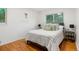 Tranquil bedroom with hardwood floors, a comfortable bed, and soft, natural lighting at 2840 S Yates St, Denver, CO 80236