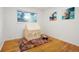 Charming bedroom featuring hardwood floors, whimsical decor, and ample natural light at 2840 S Yates St, Denver, CO 80236