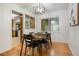Dining room with hardwood floors, contemporary lighting, and a view into another room at 2840 S Yates St, Denver, CO 80236