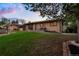 Expansive lawn showcasing a ranch style home with brick exterior and mature trees at 2840 S Yates St, Denver, CO 80236