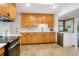 Well-lit kitchen showcasing wood cabinets, stainless steel appliances, and a modern faucet at 2840 S Yates St, Denver, CO 80236