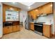 Bright kitchen featuring wood cabinets, stainless steel appliances, and a cozy breakfast nook at 2840 S Yates St, Denver, CO 80236