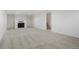 Spacious living room with a white brick fireplace and plush carpeting at 2840 S Yates St, Denver, CO 80236