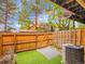Private backyard with artificial grass, patio area, and wood fence at 2627 E Nichols Cir, Centennial, CO 80122