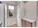 Bright kitchen features a functional layout, white appliances, and a charming window at 2627 E Nichols Cir, Centennial, CO 80122