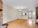 Open living room features laminate flooring, a cozy stone fireplace, and access to kitchen bar at 2627 E Nichols Cir, Centennial, CO 80122