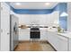 Modern kitchen featuring white cabinetry, stainless steel appliances, and hardwood floors at 8361 E 29Th Ave, Denver, CO 80238