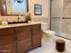 Bathroom with a wood vanity, granite countertops and a glass shower door at 390 Zang St # 5-102, Lakewood, CO 80228