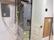 Furnace room featuring a newer Rheem unit, circuit box, and small window at 390 Zang St # 5-102, Lakewood, CO 80228